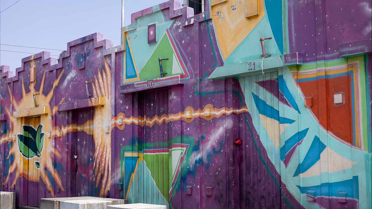 Colorful mural in El Alto, Bolivia, depicting geometric and natural patterns near a place where witches read fortunes