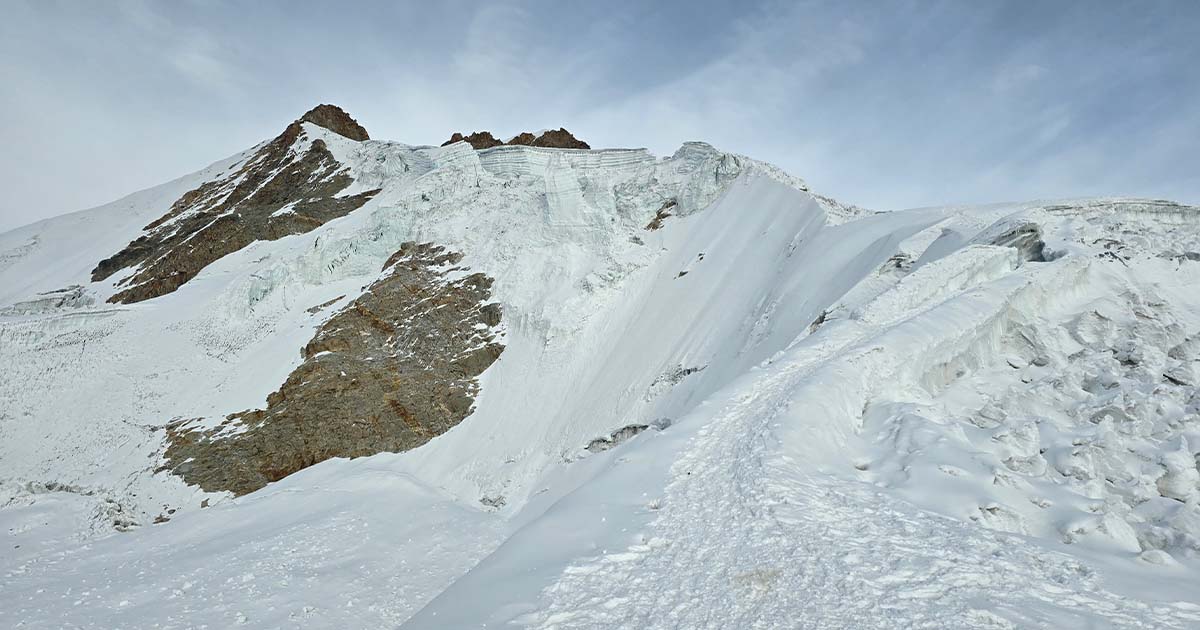 Snow-covered ridge and rocky peaks on Huayna Potosí in Bolivia