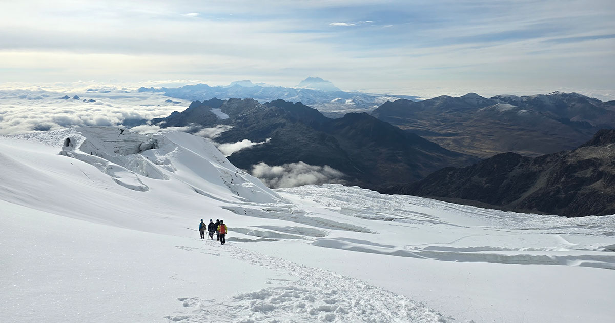 Descending through the snowfields with the vast Andean range in view.