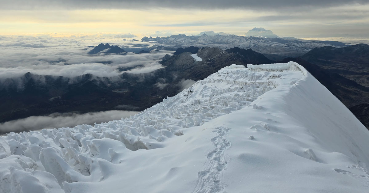 A path through the snow, overlooking the sprawling Andean landscape.