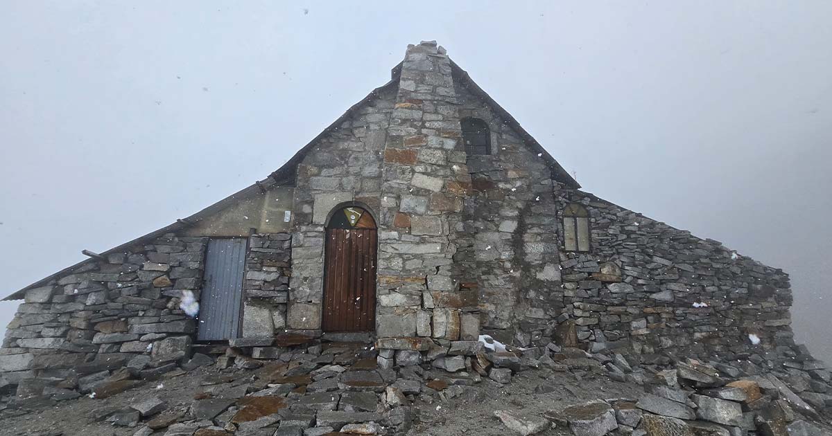 Inside the high camp on Huayna Potosí, with bunk beds and mountaineering gear.