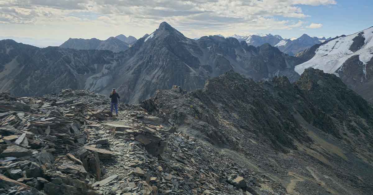 Hikers descending from Pico Austria with lakes and valleys in the background