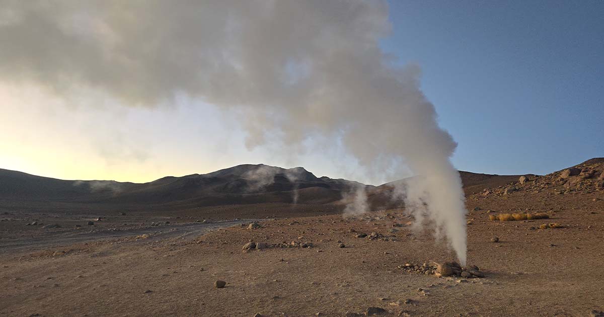 Steam rising at sunrise from one of the geysers in Sol de Mañana.