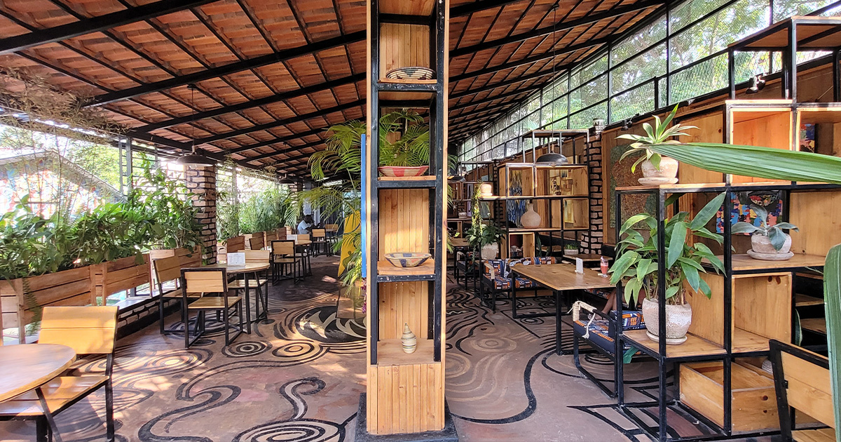 Café interior in Rwanda with wooden furniture and plant decor