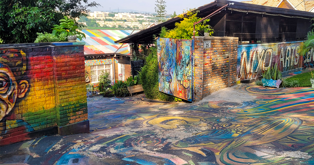 Artistic murals on the walls of an outdoor gallery in Rwanda