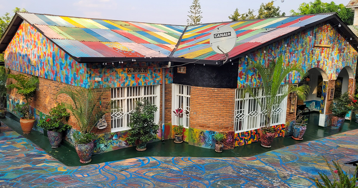 Colorfully painted art gallery exterior with plants and satellite dish in Rwanda