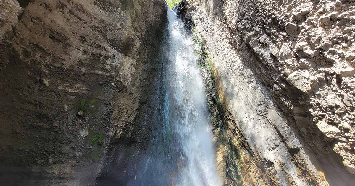 Waterfall cascading down a rocky cliff face on Mount Meru