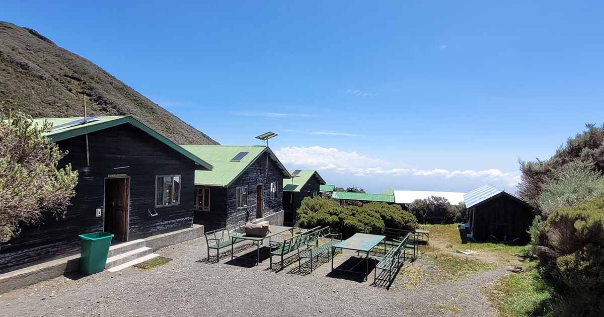 Mountain huts along the hiking trail on Mount Meru with clear blue skies